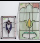 Two early 20th century Art Nouveau stained glass panels with leaded borders and coloured glass
