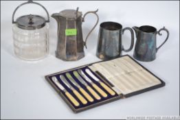 A collection of early 20th century silver plated wares to include a cut glass biscuit barrel with