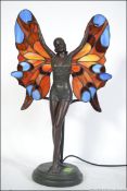 A contemporary Tiffany style table lamp being wired having a central nymph figure with coloured