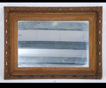 A large mid century 1950's gilt wall mirror in fret worked oversized frame with central bevelled