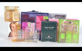 A collection of ladies perfumes to include examples by Cartier, Tommy, Woodspice,