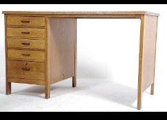 A good mid century Air Ministry style oak desk raised on tapering legs that remove having end bank