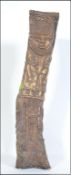 A large African bone sculpture totem decorated with scenes of snake charmer, deity,