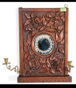 A Victorian carved oak framed gypsy hall mirror carved with flowers and foliates in the 