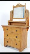 An early 20th century satin walnut dressing table chest of drawers with shaped mirror over three