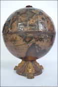 A vintage 20th century antiqued style drinks globe having a hinged top opening revealing storage
