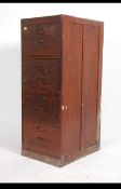 A 1930's Air Ministry four drawer wooden filing cabinet, dark stained with metal pull handles.