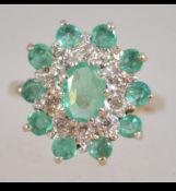 A 9ct gold cluster ring set with green stones and diamonds. Weight 4.4g. Size Q.5.