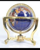 A 20th century Lapis Lazuli spherical globe being raised on a gilded metal stand.