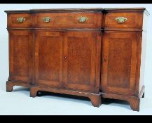 A Queen Anne revival breakfront sideboard in walnut with crossbanded finish.