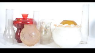 A large quantity of glass oil lamp shades