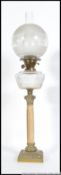 An early 20th century brass and marble oil lamp raised on a three tier square base with marble