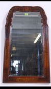 A stunning 20th century Victorian style inlaid walnut bevel edge mirror having a shaped frame with