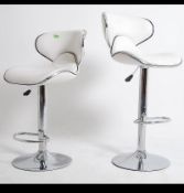 A group of 4 20th century retro chrome bar / kitchen stools with white seat pads in the manner of