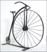 A vintage 20th century shop display metal framed bicycle in the form of a Penny Farthing.