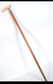 A 19th century gentlemans walking cane having a Ivory handle above a silver hallmarked collar on a