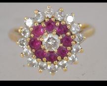 A hallmarked 18ct gold ruby and diamond cluster ring. Diamonds approx 1ct. Size O.5. Weight 6.