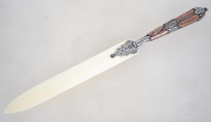 A 19th century paper knife / page turner having a silver inlaid scottish pebble ware handle.