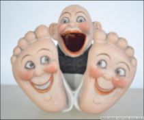 An early 20th century Schafer & Vater Figural bisque ware match holder in the form of a man with