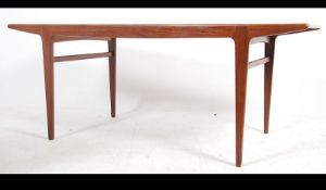 A 1970's retro teak wood Youngers dining table of rectangular form having tapering legs with