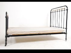 A Victorian cast iron painted 3/4 bed raised on ceramic castors united by the bed rails.