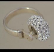 A silver and cz ball ring raised on a reeded shank. Total weight 6.1g / Size L.