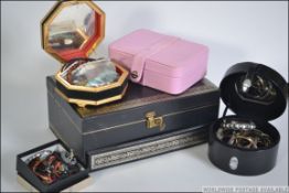 A good group of jewellery boxes some with contents to include large metamorphic example with lock