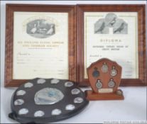 A collection of silver hallmarked pigeon racing medals set to a wooden plaque with silver notation