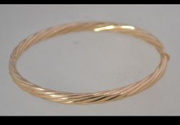 A hallmarked 9ct gold bangle bracelet with hidden clip clasp. Hallmarked Sheffield. Weight 10.
