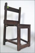 An arts & crafts small childs folding oak chair from the early to mid 20th century in oak.
