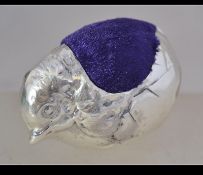 A large silver pin cushion in the form of a chick having a purple velour cushion. Total weight 31.