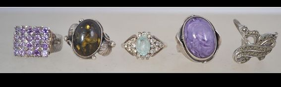 A collection of 5 silver rings to include pave set, stone set, aquamarine coloured stone etc.