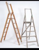 2 vintage wooden folding a-frame industrial ladders ideal as upcycled bookshelves.