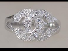 WITHDRAWN A silver and interlocking ' C ' Chanel style ring. Size R / Weight 6.4g.