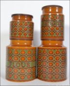 A set of 1950's Hornsea ' Bronte ' pattern storage jars of graduating sizes being stamped to the