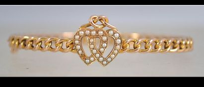 A 15ct gold and seed pearl bracelet with entwined heart motif set with seed pearls with knot having