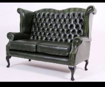 Antique Chesterfield Style mahogany and leather button back two seat sofa settee being raised on
