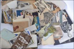 A collection of postcards together with black and white photographs dating from the 20th century
