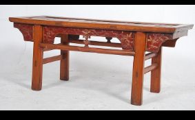 A 20th century Chinese hardwood and bamboo coffee table having a slatted bamboo framed top raised
