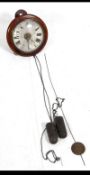 A Victorian mahogany postman's clock with round face and convex glass together with twin lead