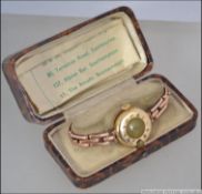 A vintage circa 1930's ladies 18ct gold wrist watch the half hunter case with white enamel face and