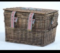 A contemporary Joule whicker hamper complete with contents together having canvas strapping and