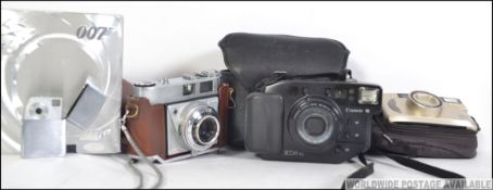 A collection of cameras to include digital and vintage with makes such as Kodak, Nikon,