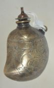 A 19th century small Islamic bronze powder flask of unusual form having etched decoration with