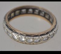 A 9ct gold eternity ring set with white stones. Marked 9ct, tests 9ct gold. Size N. Weight 3.2g.