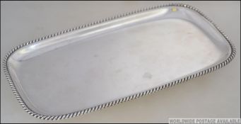 A sterling silver salver marked 925 of rectangular form with gadrooned edges.