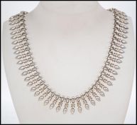 A stunning late 19th early 20th century ladies silver dog tooth style necklac.