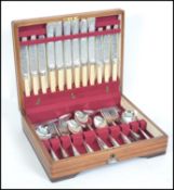 A good mid 20th century complete oak cased canteen of silver plated cutlery consisting of a six