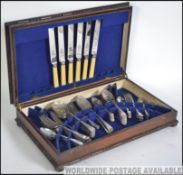 An early 20th century canteen of cutlery by Viners set in baize lined box with sectional interior.