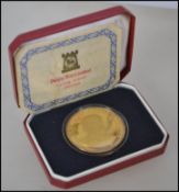 A gilded silver Pobjoy mint coin to celebrate the first scheduled flight from London to New York